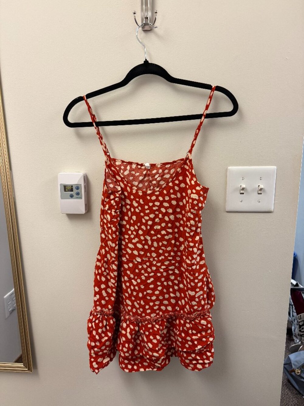 orange/red flowy top with cream spots